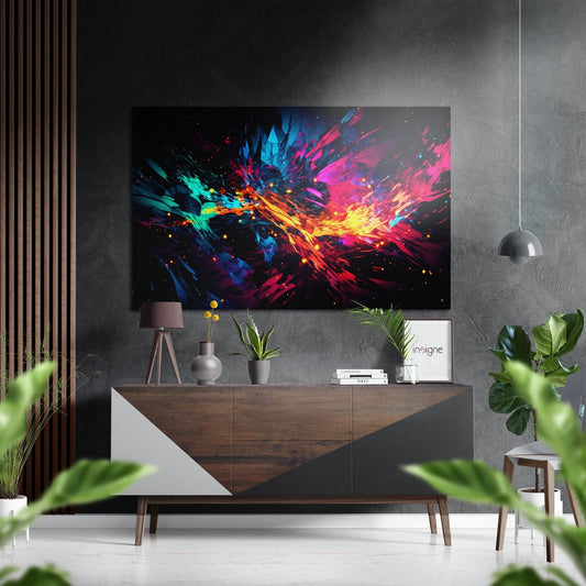 Vibrant abstract artwork with blue, pink, yellow, and orange shard-like brushstrokes displayed above a wooden console table in modern interior setting.