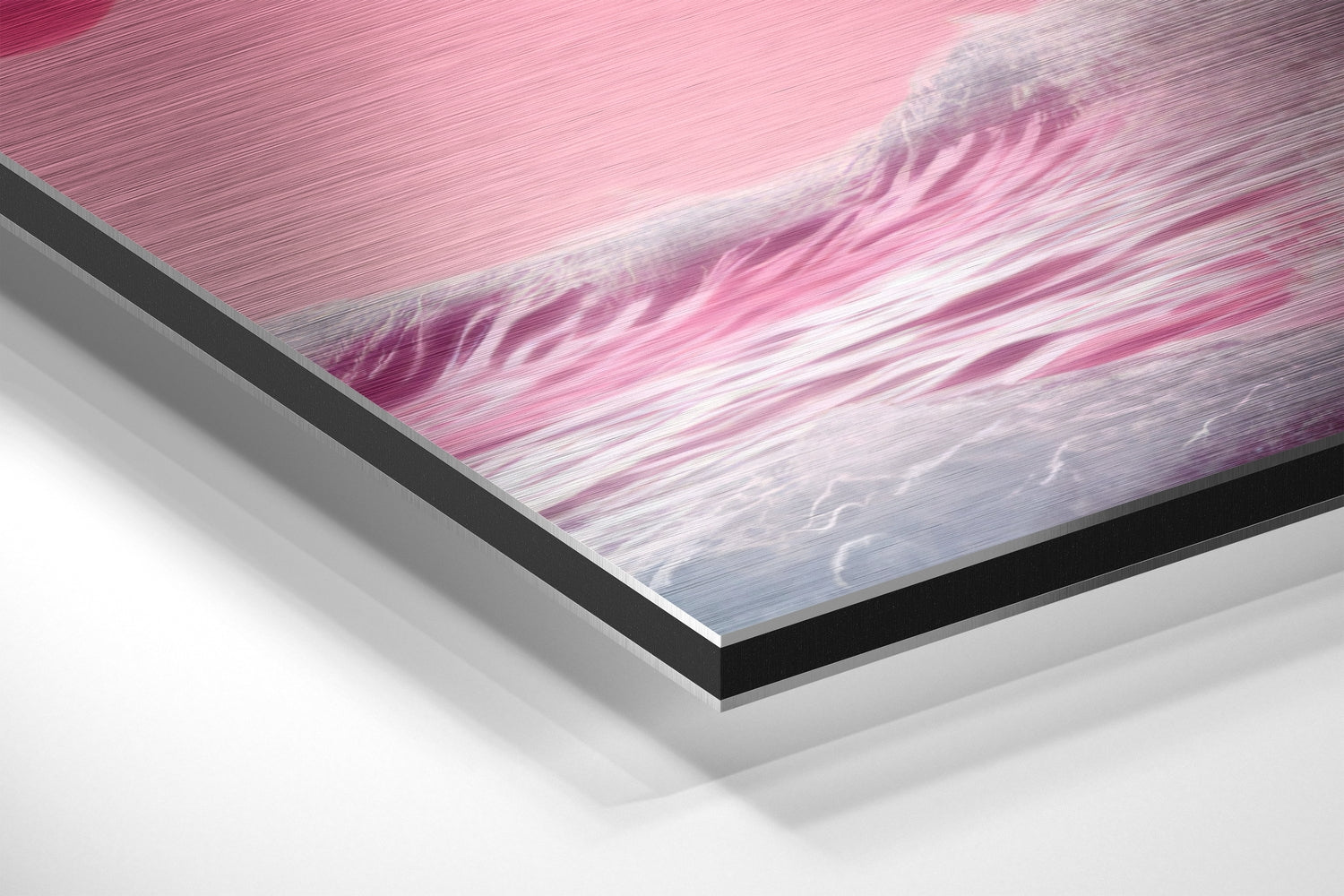 Close-up angled view of layered brushed aluminum and black edge framing pink and blue wave artwork.