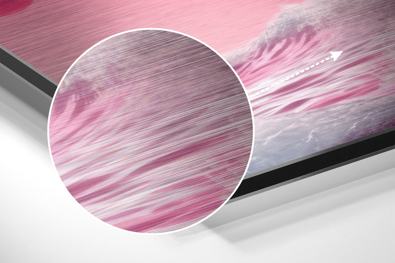 Close-up circular detail of pink and white brushed aluminum surface with horizontal texture lines and motion blur effect.
