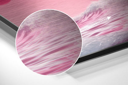 Close-up circular detail of pink and white brushed aluminum surface with horizontal texture lines and motion blur effect.