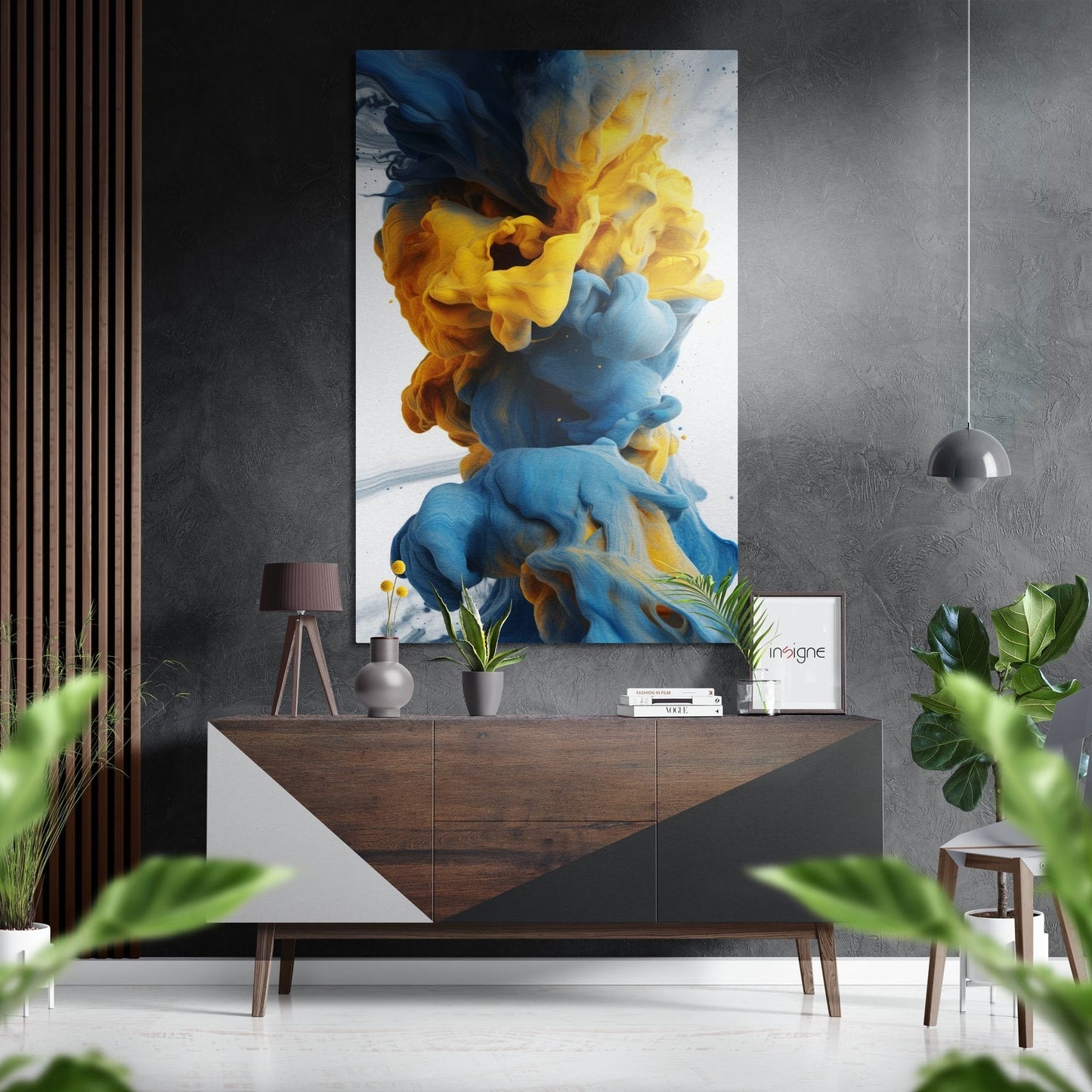 Vibrant blue and yellow ink swirls displayed on brushed aluminum panel above mid-century wooden console in modern interior setting.