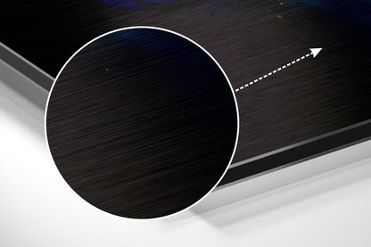 Angled 3D product view of circular brushed aluminum Dibond wall art with white outline and directional arrow on dark striped background.