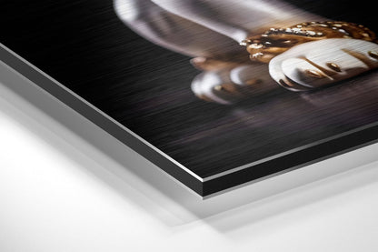 Close-up angled view of brushed aluminum dibond wall art showing layered material edge with printed puppy photograph on top surface.