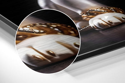 Close-up detail of brushed aluminum surface with brown and white puppy photograph, showing texture and metallic finish.