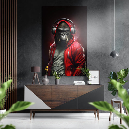 Gorilla wearing red hoodie and headphones displayed on gallery wall above wooden console in modern interior setting.