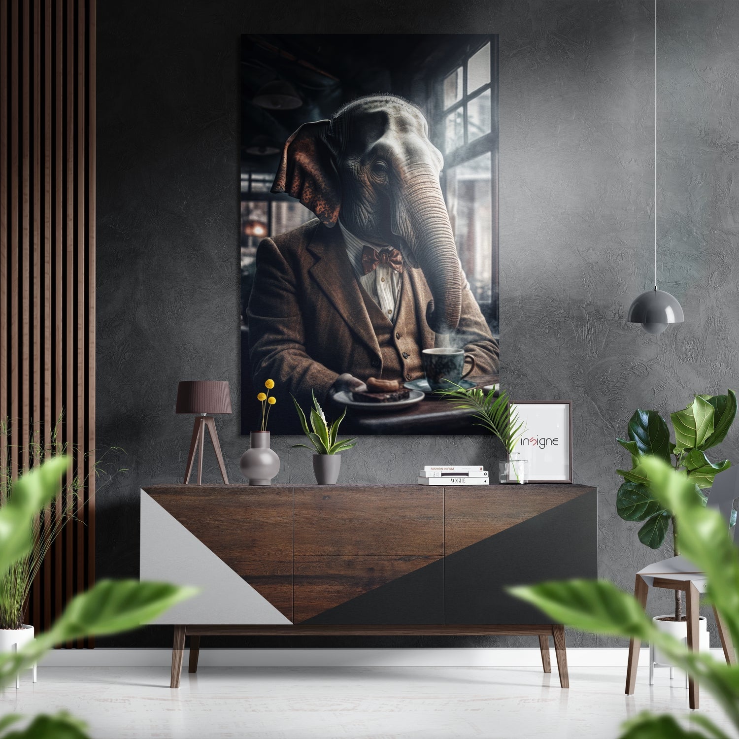 Framed wall art depicting an anthropomorphic elephant in brown jacket and bow tie seated at a table, displayed above a wooden mid-century console in a modern interior setting.