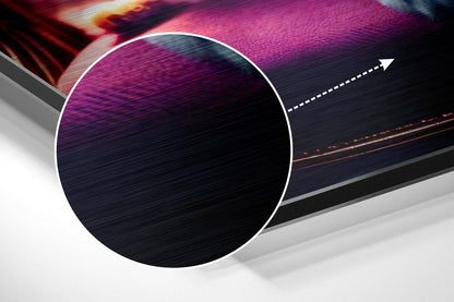 Close-up angled view of brushed aluminum Dibond wall art featuring a white-bordered circle with purple and dark blue textured surface and directional arrow graphic.