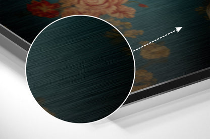 Close-up angled view of brushed aluminum Dibond wall art featuring a white-bordered circular panel with teal and gold floral pattern, white dashed directional arrow.