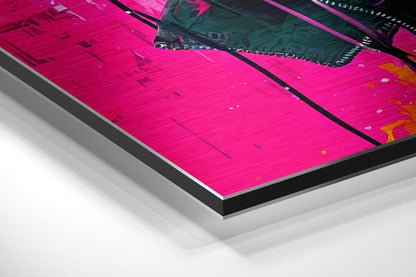 Angled close-up view of vibrant magenta brushed aluminum Dibond print showing layered mounting construction with black border and white backing visible.