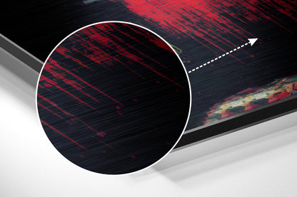 Close-up angled view of brushed aluminum Dibond wall art with red and black diagonal striped pattern and white circular overlay detail.