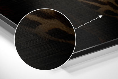 Close-up angled view of brushed aluminum circular disc with white border and directional arrow, showing metallic surface texture and shadow detail.