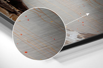 Close-up detail of brushed aluminum surface with orange grid lines and red accents, showing texture and finish of Dibond wall art.