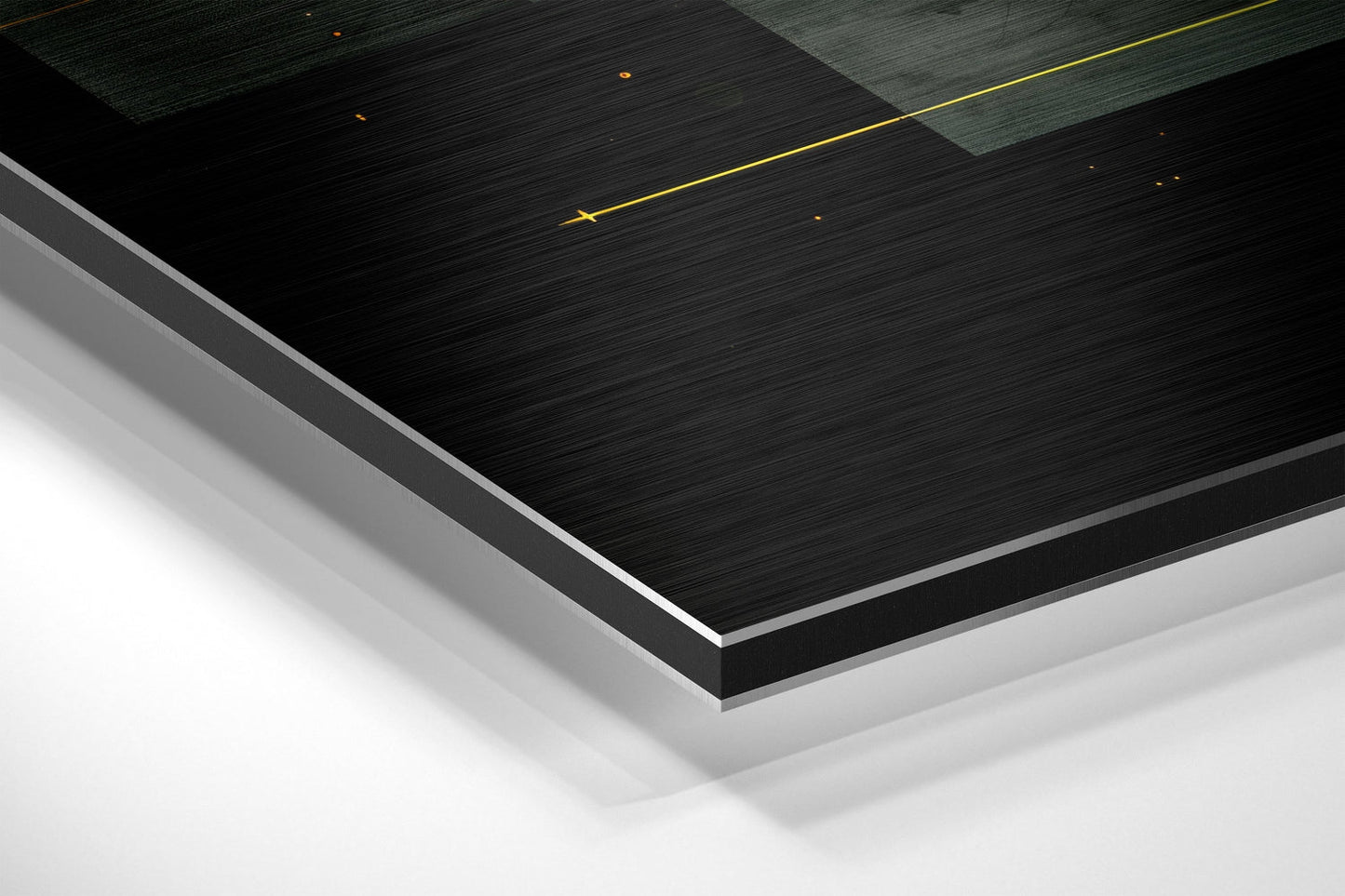Layered angled view of brushed aluminum Dibond panels in black and white with gold accent lines against white background.
