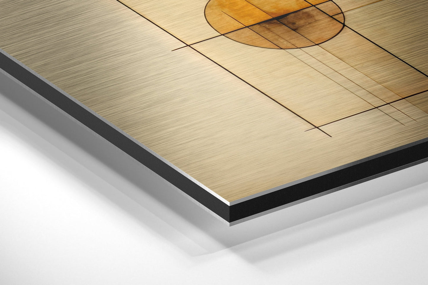 Close-up angled view of brushed aluminum Dibond panel with black edge trim and circular design detail in warm wood tones.