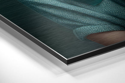 Close-up angled view of layered Dibond panel showing brushed aluminum surface with teal water and brown dog silhouette detail.