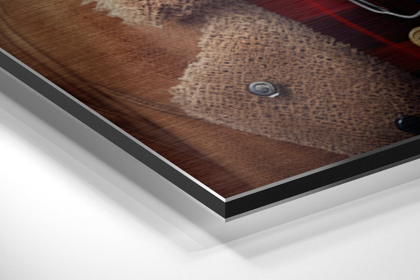 Close-up angled view of brushed aluminum Dibond wall art showing layered edge detail and brown textured dog portrait surface.