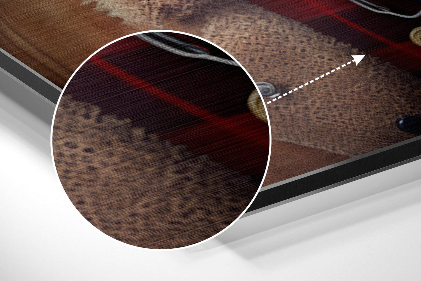 Close-up detail of brushed aluminum surface showing wood grain texture and red striping with white circular highlight and directional arrow.