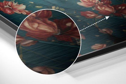 Close-up detail of brushed aluminum surface with red floral pattern and directional arrow indicator on teal background.