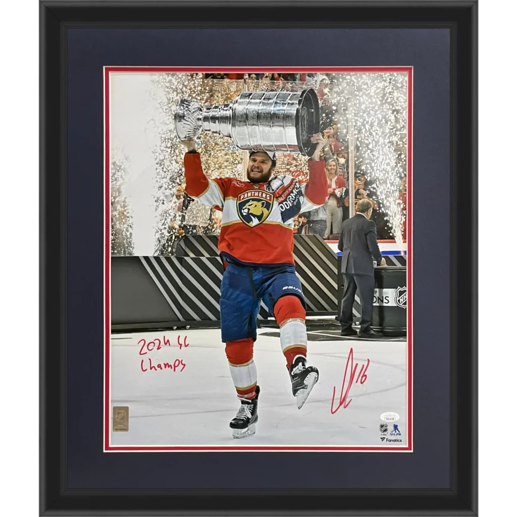 Autographed Florida Panthers Aleksander Barkov holding Stanley Cup trophy