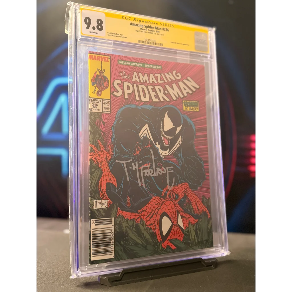 A signed amazing spider-man #316 comic book encased in a clear slab with yellow cgc 9.8 grading label and venom cover