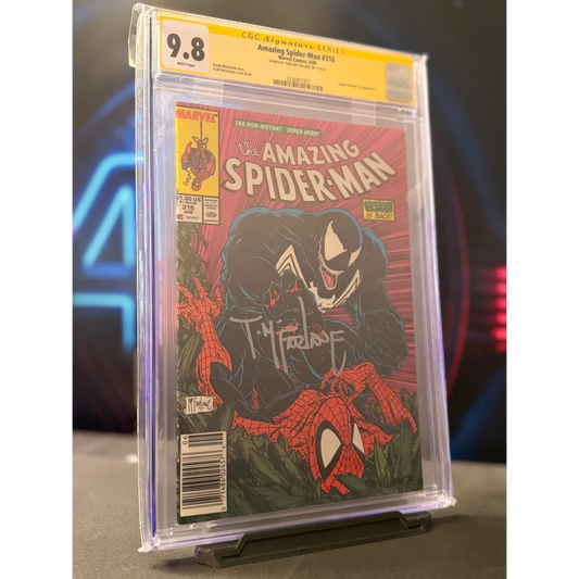A signed amazing spider-man #316 comic book encased in a clear slab with yellow cgc 9.8 grading label and venom cover