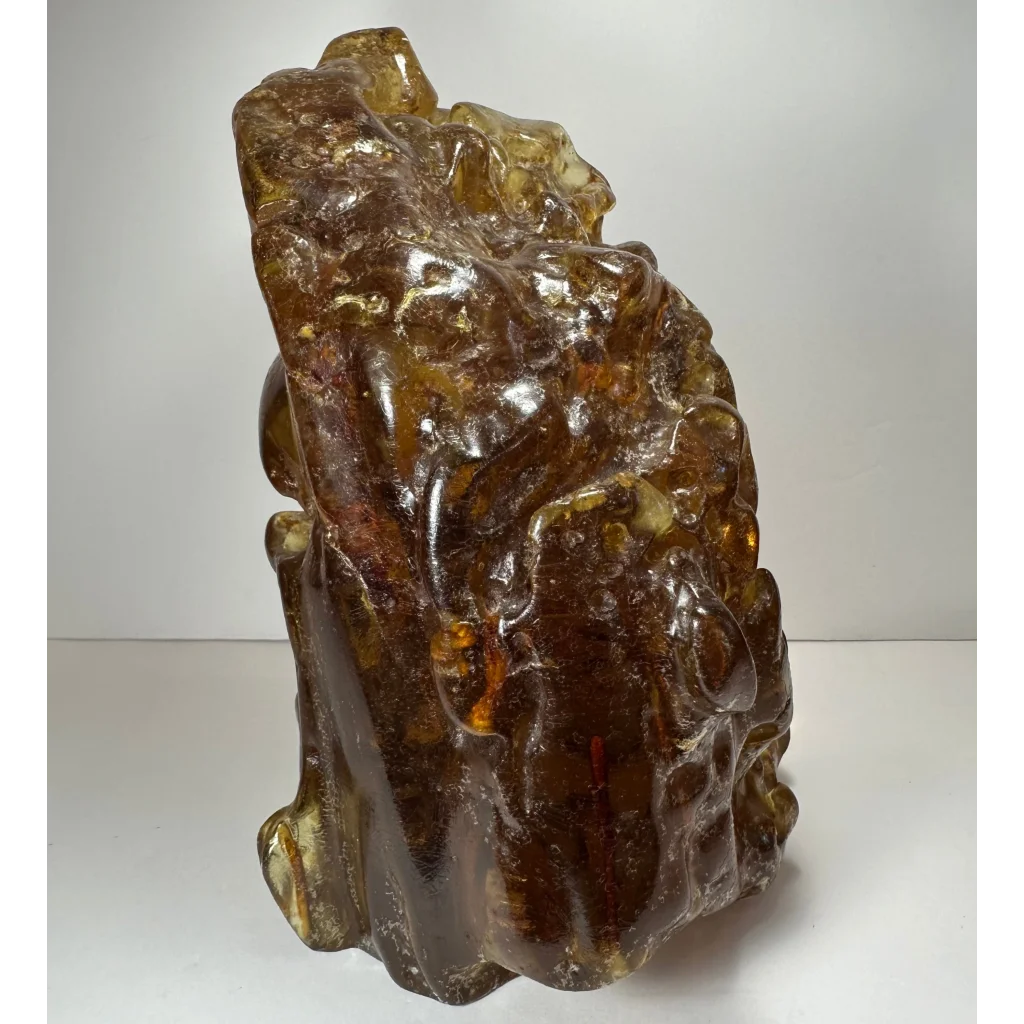 Translucent amber termite hill resin sculpture with intricate carvings