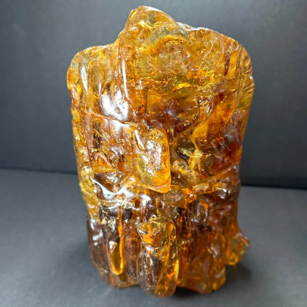 Translucent amber termite hill resin sculpture with carvings and inclusions
