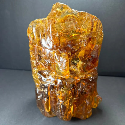 Translucent amber termite hill resin sculpture with carvings and inclusions