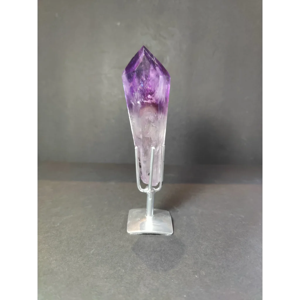 Amethyst polished scepter wand with deep purple to translucent white crystal on minimalist silver stand