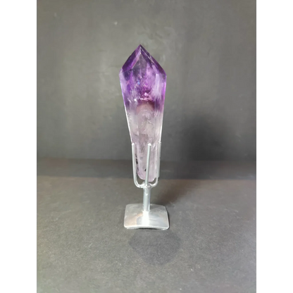 Amethyst polished scepter wand with deep purple to translucent white crystal on minimalist silver stand