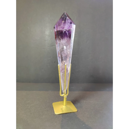 Amethyst polished scepter wand with a deep purple to clear gradient on an elegant gold-colored metal stand