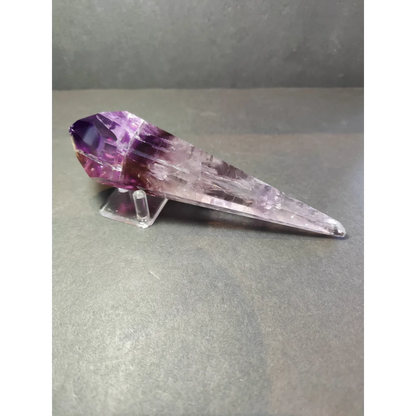 Amethyst polished scepter wand with deep purple to translucent lavender facets and natural mineral inclusions on metal stand
