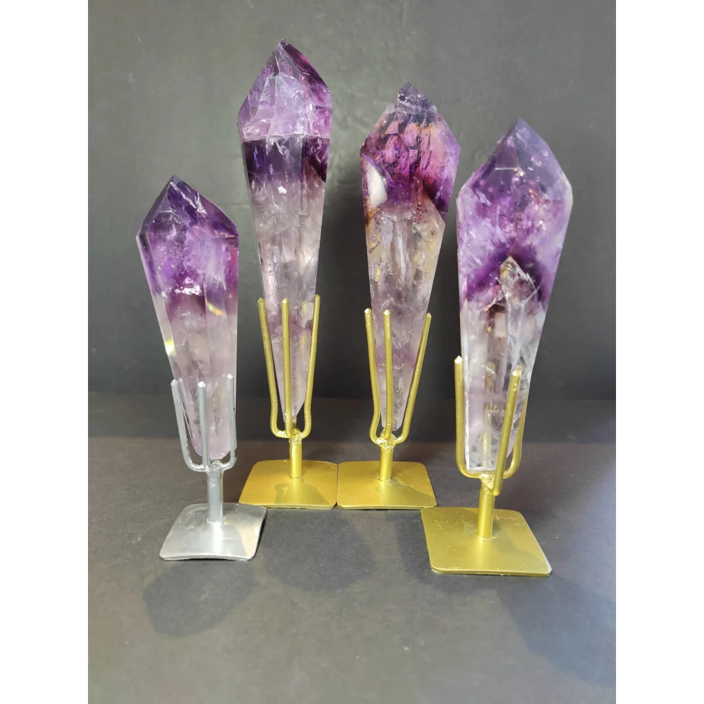 Four amethyst polished scepter wand crystal points mounted on metal stands with gold and silver finishes