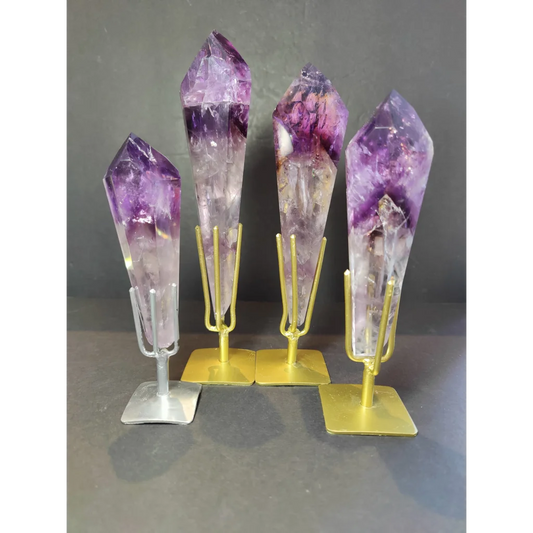 Four amethyst polished scepter wand crystal points mounted on metal stands with gold and silver finishes