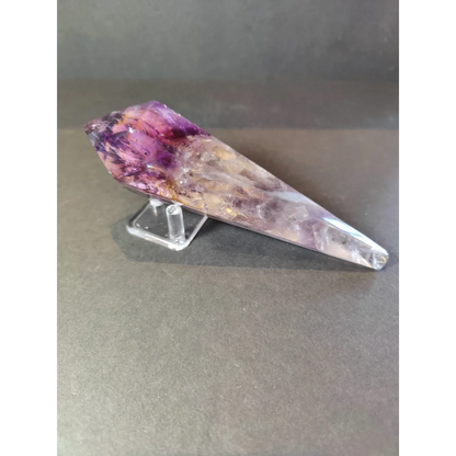 Amethyst polished scepter wand with translucent purple and clear crystal point on a transparent acrylic metal stand
