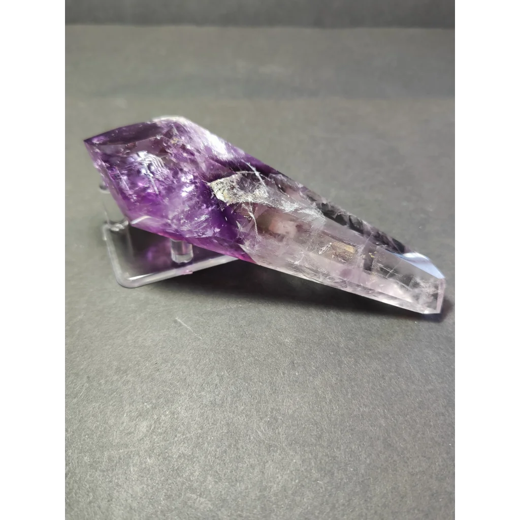 Amethyst polished scepter wand with translucent purple crystal and internal inclusions on clear acrylic metal stand