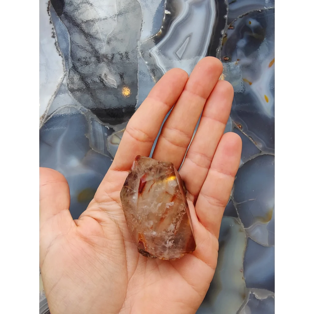 Amphibole angel phantom quartz Brazil geode in palm