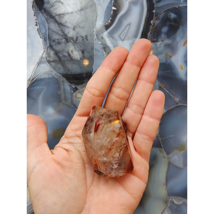 Amphibole angel phantom quartz Brazil geode in palm