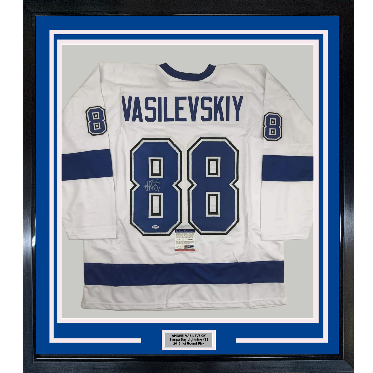 Framed white Tampa Bay Lightning hockey jersey number 88 with "VASILEVSKIY" name plate and autograph, displayed against blue matting in black frame.