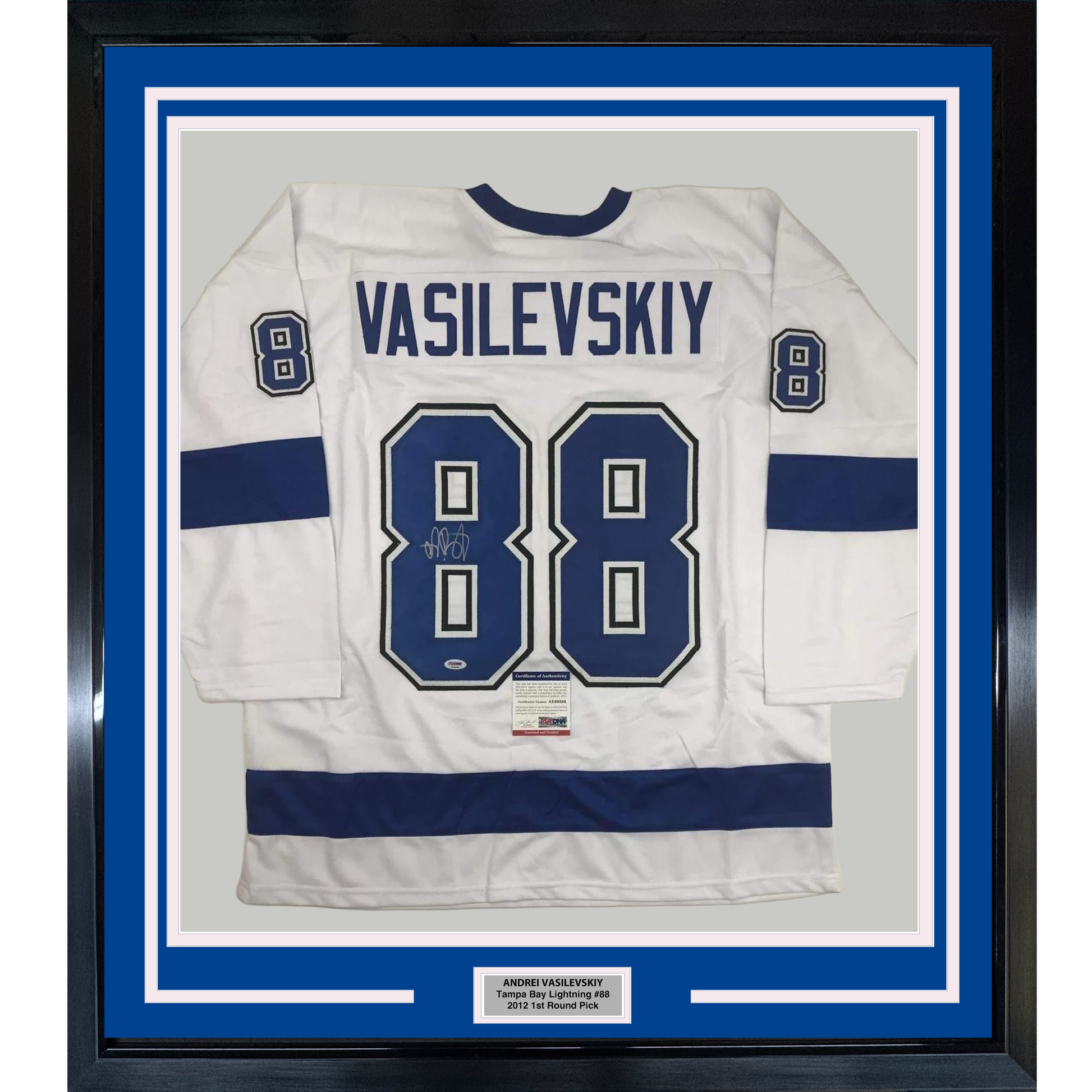 Framed white Tampa Bay Lightning hockey jersey number 88 with "VASILEVSKIY" name plate and autograph, displayed against blue matting in black frame.