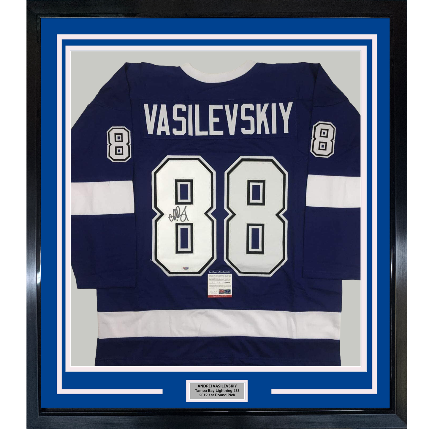 Framed navy and white Tampa Bay Lightning jersey number 88 with "VASILEVSKIY" nameplate and autograph, displayed flat against blue matting.