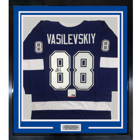 Framed navy and white Tampa Bay Lightning jersey number 88 with "VASILEVSKIY" nameplate and autograph, displayed flat against blue matting.