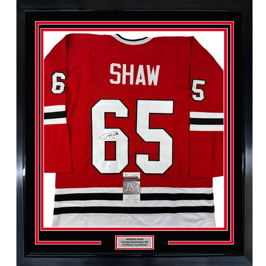 Red Chicago Blackhawks jersey #65 with Shaw name and signature displayed in black frame with red and white mat borders.