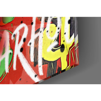 Vibrant graffiti glass wall art with bold red, yellow, white lettering and black splatters