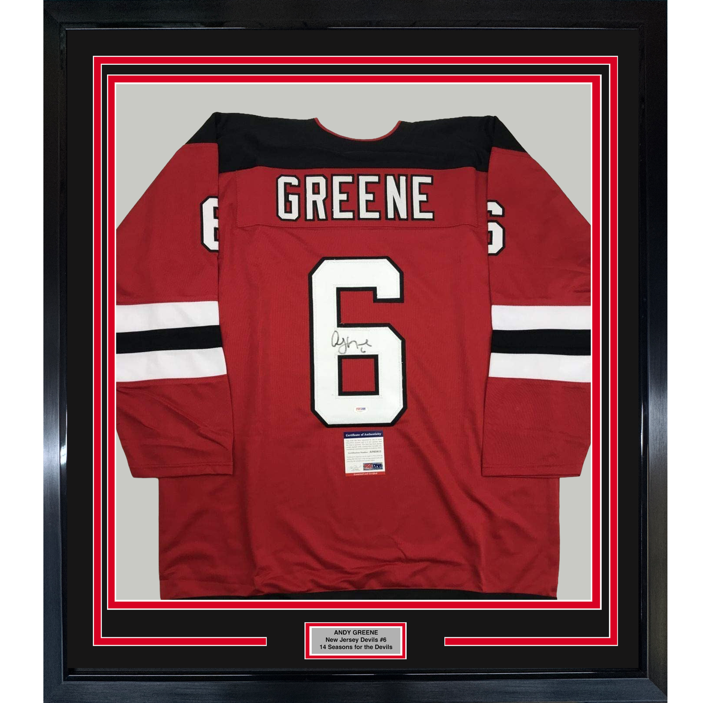 Red New Jersey Devils hockey jersey number 6 with Greene nameplate, signed, displayed flat in black frame with white matting and authentication certificate visible.