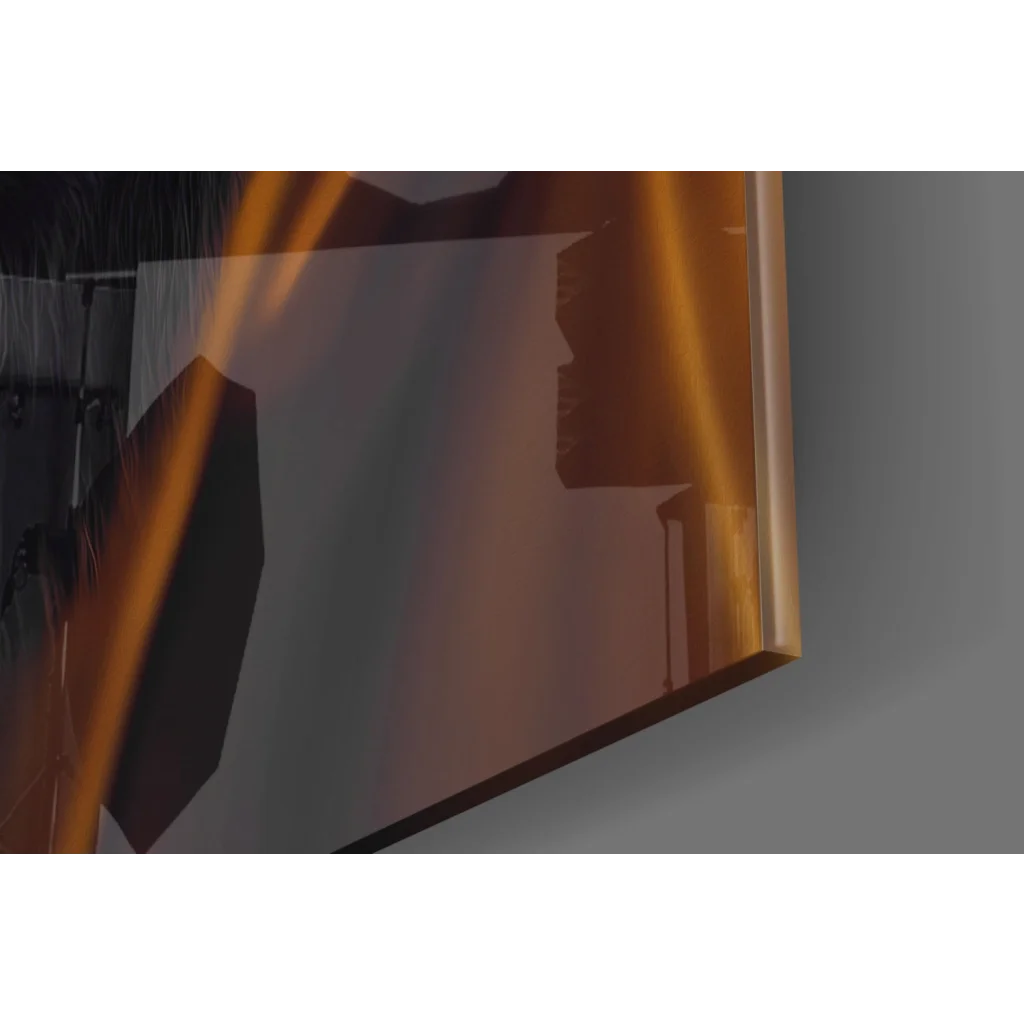 Sleek gold-framed glass wall art reflecting warm studio light