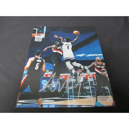 Autographed 8x10 photo of Anthony Edwards dunking over Trail Blazers player