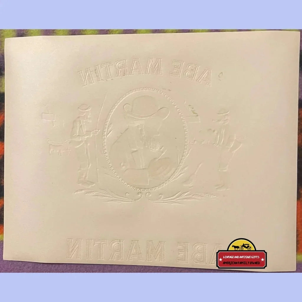 Embossed paper featuring a circular design and text from the Abe Martin cigar label