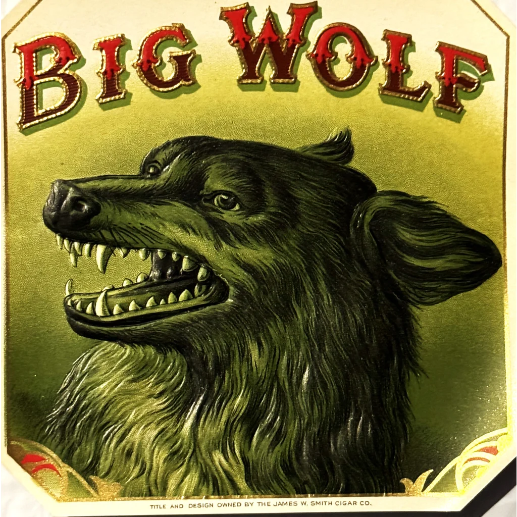 Fierce green wolf with bared teeth above Big Wolf text in Antique 1900s collectible