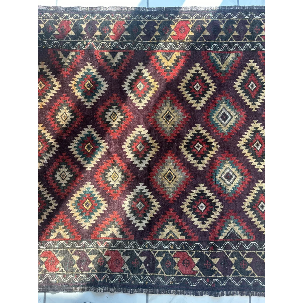 Antique 1900s tribal Baluch wool rug with diamond pattern